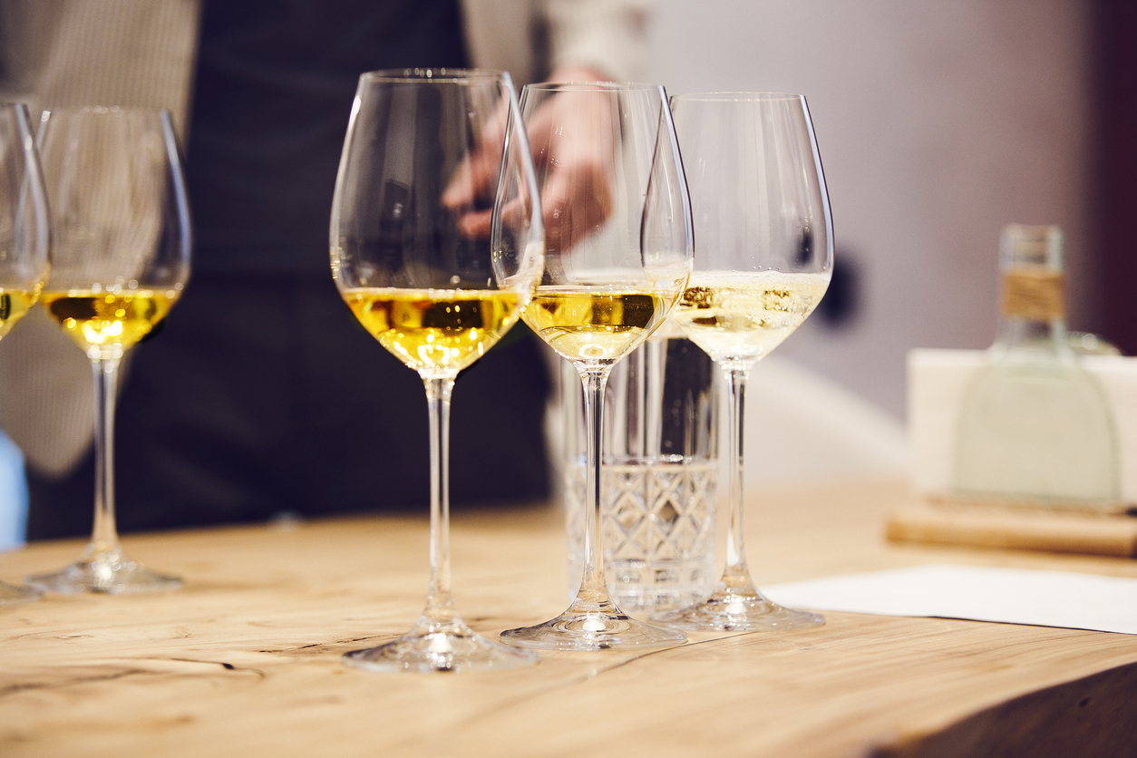 Elegant Wine Glasses With Different White And Sparkling Wines On The Table During The Preparation For The Tasting. Sommelier School, Professional Certification, Winemaking Association. Stylistics And Geography Of Wines.